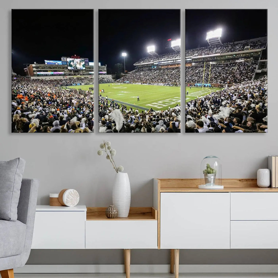 Showcased as premium wall art, this gallery-quality canvas features a print of the Georgia Tech Yellow Jackets Football Team at Atlanta's Bobby Dodd Stadium during a crowded, illuminated night game.