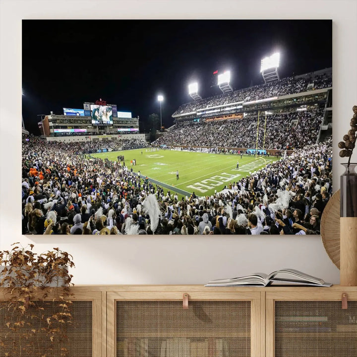 Showcased as premium wall art, this gallery-quality canvas features a print of the Georgia Tech Yellow Jackets Football Team at Atlanta's Bobby Dodd Stadium during a crowded, illuminated night game.