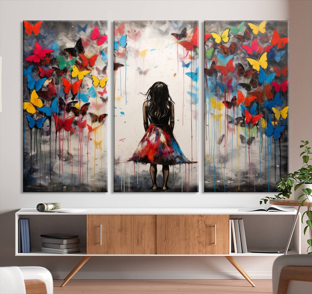 The Girl Butterfly Graffiti Abstract Canvas Print, featuring a vibrant depiction of a girl surrounded by butterflies on museum-quality canvas, is displayed prominently.