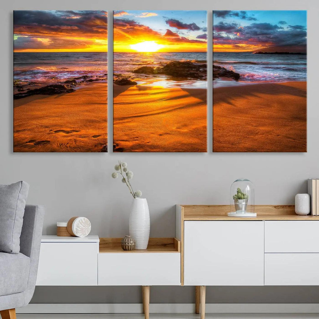 The vibrant panoramic view captured in the Golden Beach Sunset Canvas Art offers a serene scene of nature's tranquil beauty over the rocky shoreline. This Giclee canvas print, featuring a gallery wrap, beautifully depicts a breathtaking seascape for your space.