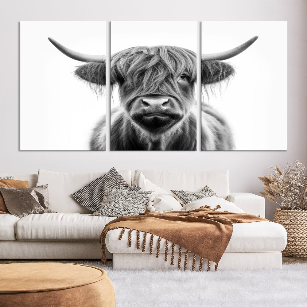 A three-panel wall art from the Highland Cow Animal Canvas series showcases a long-haired, large-horned cow. This Texas Cattle Art Print is crafted on museum-quality canvas with a UV-protective coating, making it an ideal addition to transform your living room.