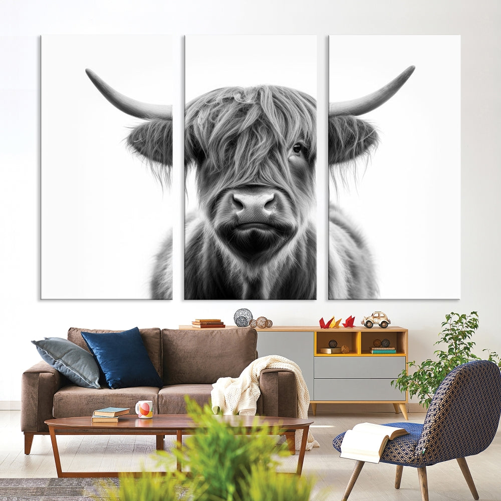 A three-panel wall art from the Highland Cow Animal Canvas series showcases a long-haired, large-horned cow. This Texas Cattle Art Print is crafted on museum-quality canvas with a UV-protective coating, making it an ideal addition to transform your living room.