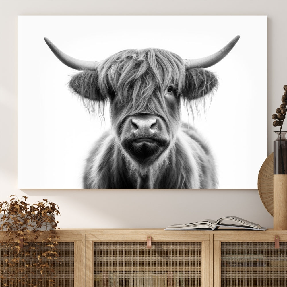 A three-panel wall art from the Highland Cow Animal Canvas series showcases a long-haired, large-horned cow. This Texas Cattle Art Print is crafted on museum-quality canvas with a UV-protective coating, making it an ideal addition to transform your living room.