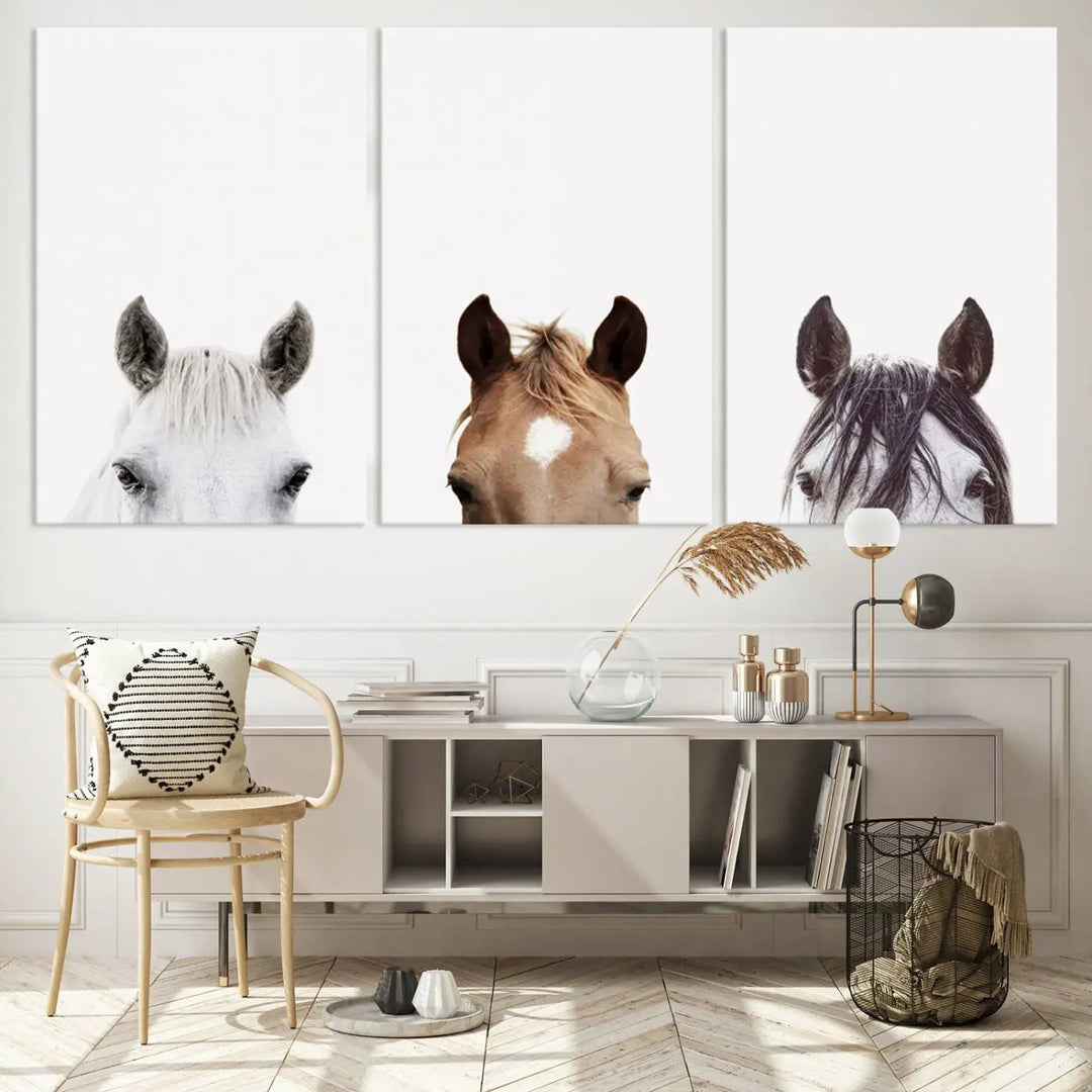 A stylish living room features the Horse Prints Set, a minimalist triptych of horse portraits crafted using giclée technology, hanging on the wall.