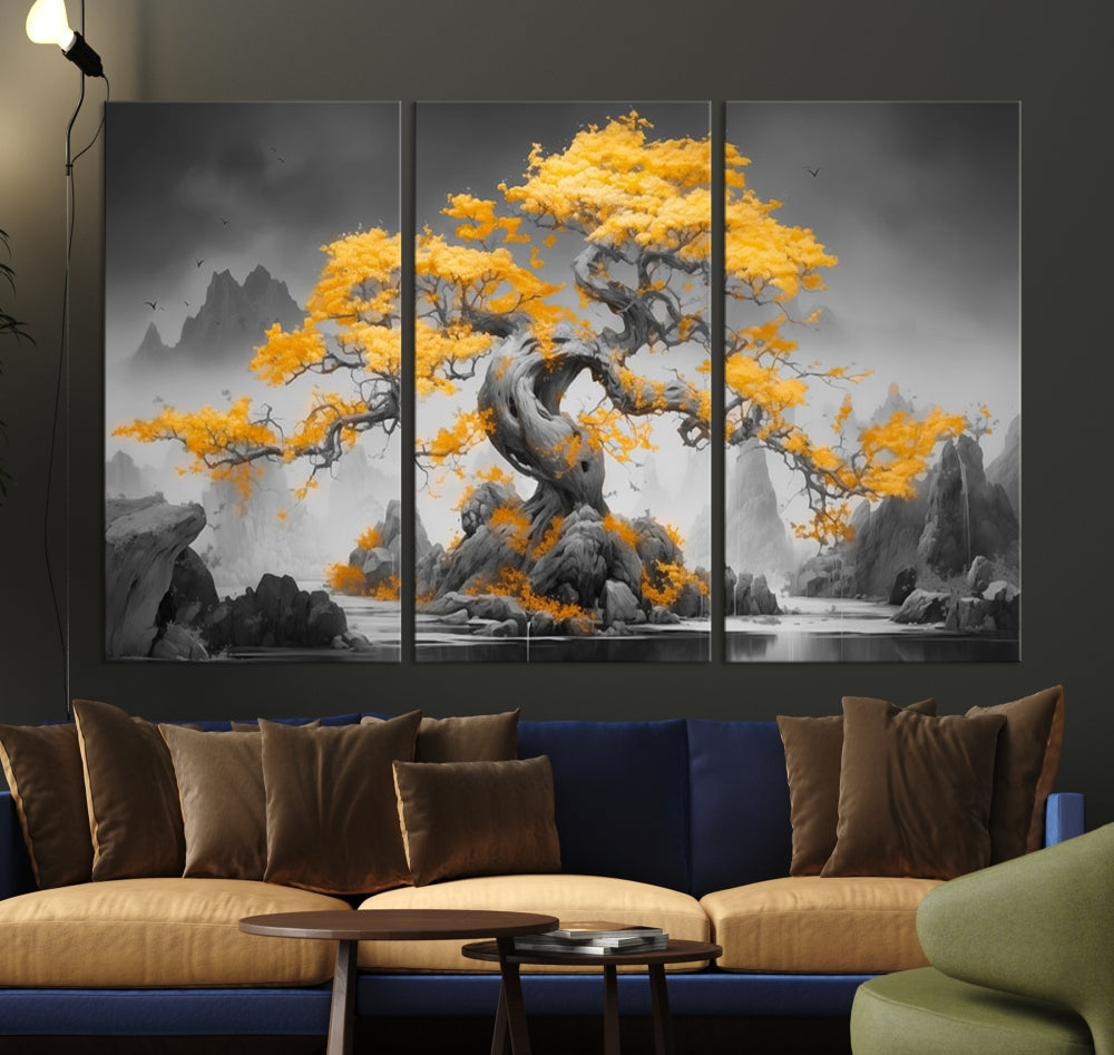 A Japanese Abstract Tree Wall Art Canvas Print showcases a vibrant yellow tree set against a misty, monochrome landscape. Each piece is gallery wrapped for lasting elegance.