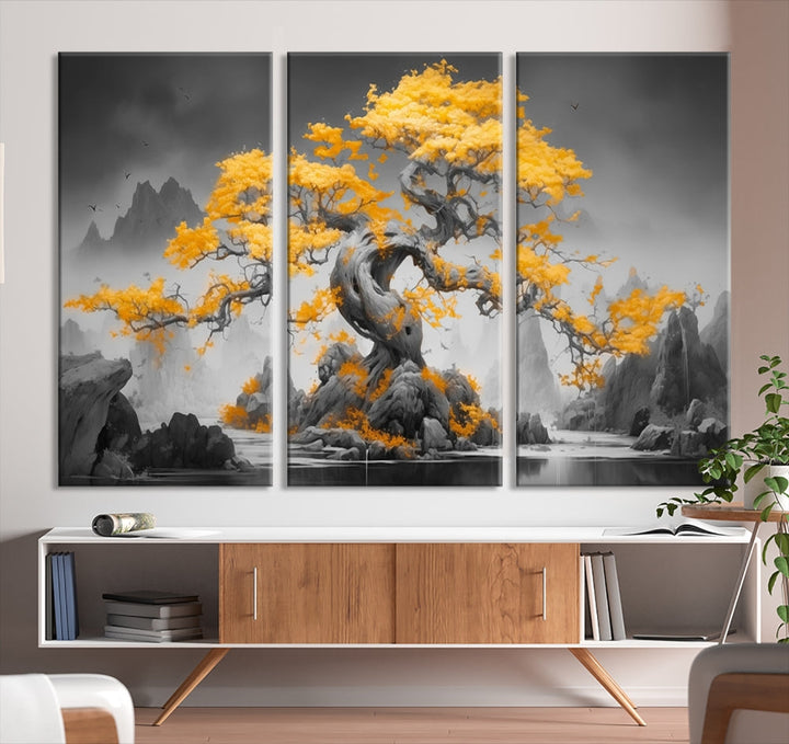 A Japanese Abstract Tree Wall Art Canvas Print showcases a vibrant yellow tree set against a misty, monochrome landscape. Each piece is gallery wrapped for lasting elegance.