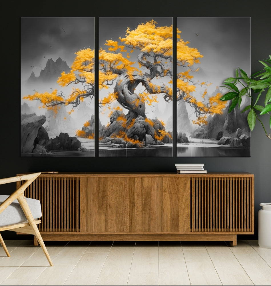 A Japanese Abstract Tree Wall Art Canvas Print showcases a vibrant yellow tree set against a misty, monochrome landscape. Each piece is gallery wrapped for lasting elegance.