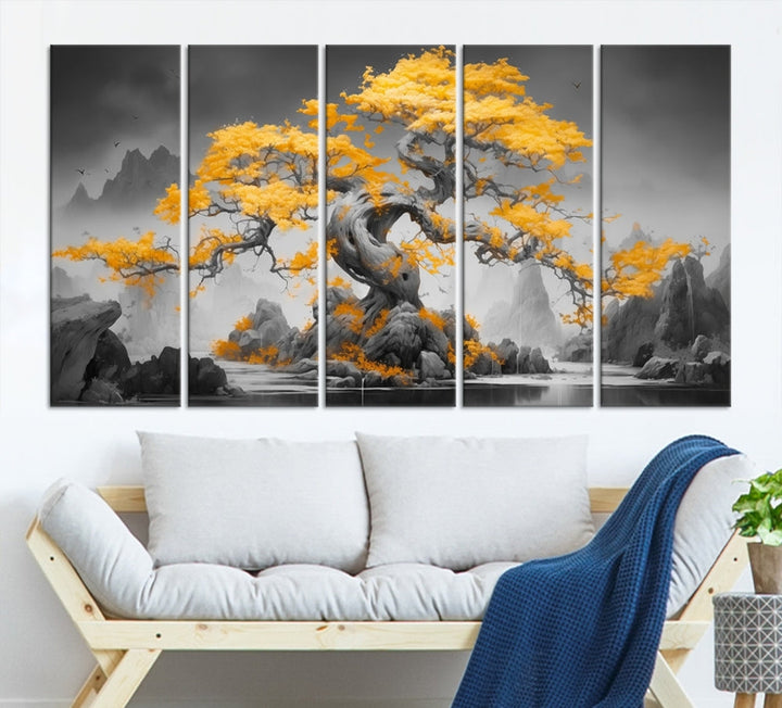 A Japanese Abstract Tree Wall Art Canvas Print showcases a vibrant yellow tree set against a misty, monochrome landscape. Each piece is gallery wrapped for lasting elegance.