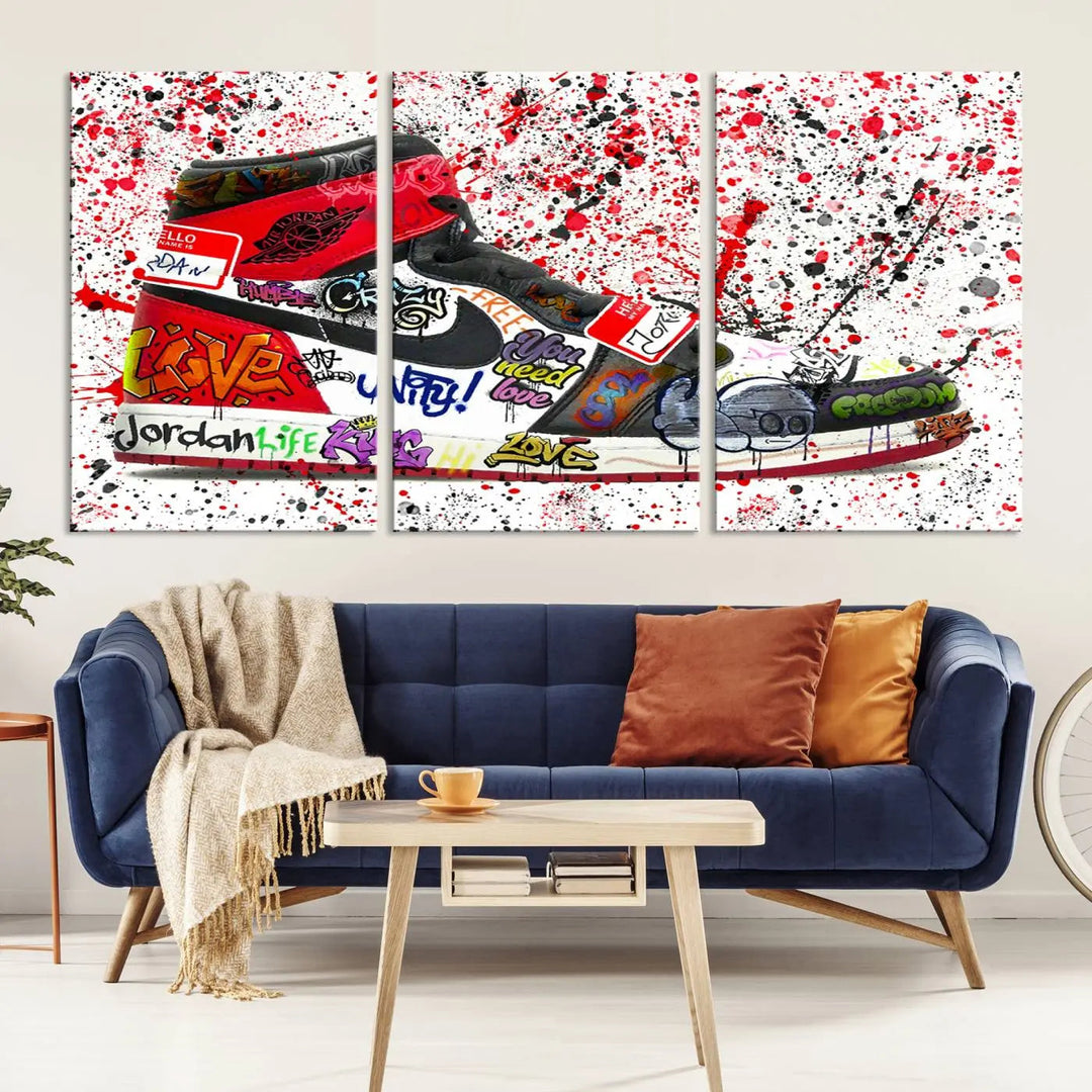 A large triptych mural titled "Jordan Shoes Graffiti Wall Art Canvas Print - Jordan Graffiti Canvas Wall Art" features images of Jordan Shoes against a splattered paint background that resembles graffiti, making it an ideal choice for sneakerheads and urban art lovers.