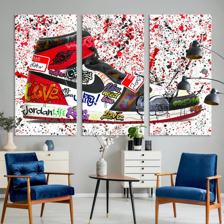 A large triptych mural titled "Jordan Shoes Graffiti Wall Art Canvas Print - Jordan Graffiti Canvas Wall Art" features images of Jordan Shoes against a splattered paint background that resembles graffiti, making it an ideal choice for sneakerheads and urban art lovers.