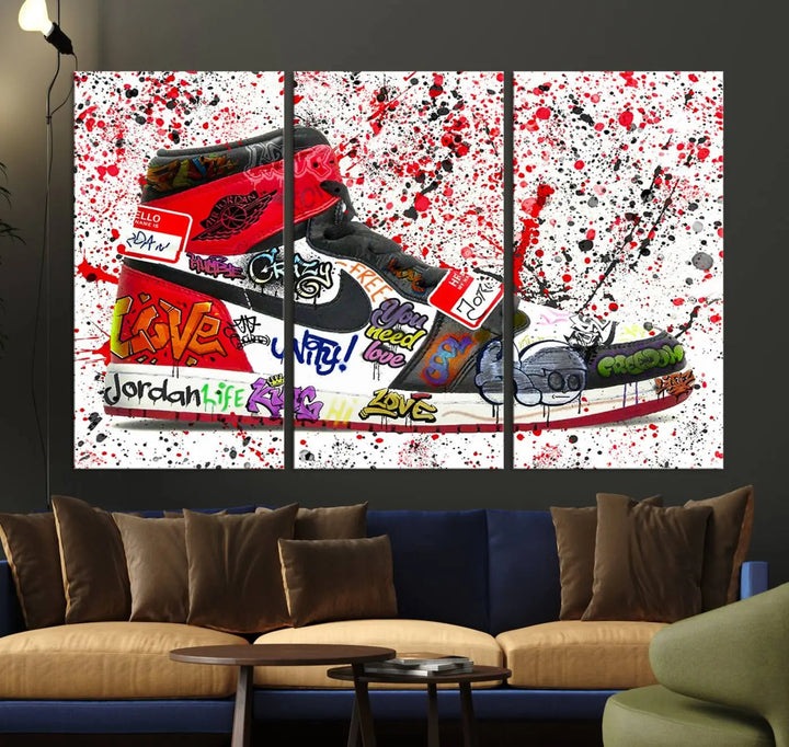 A large triptych mural titled "Jordan Shoes Graffiti Wall Art Canvas Print - Jordan Graffiti Canvas Wall Art" features images of Jordan Shoes against a splattered paint background that resembles graffiti, making it an ideal choice for sneakerheads and urban art lovers.