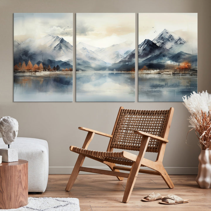 The Lake Mountain Abstract Wall Art, featuring a serene portrayal of mountains and a tranquil lake with autumn trees, is displayed on museum-quality canvas and enhanced by UV-protective coating.