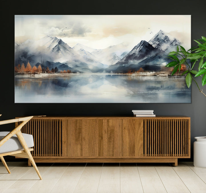 The Lake Mountain Abstract Wall Art, featuring a serene portrayal of mountains and a tranquil lake with autumn trees, is displayed on museum-quality canvas and enhanced by UV-protective coating.