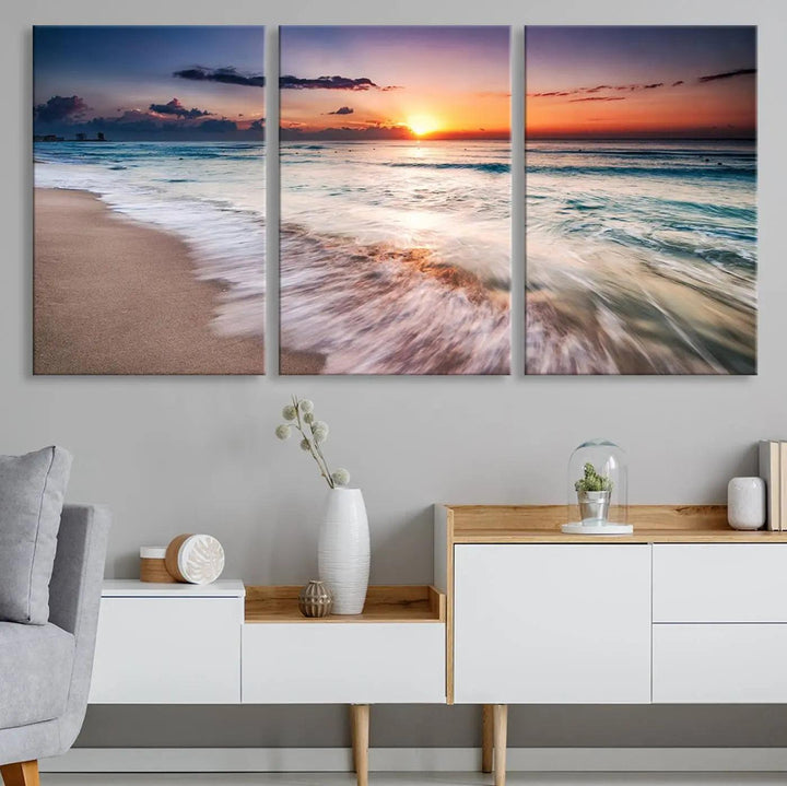 A serene triptych titled "Large Ocean Sunset Canvas Wall Art" features waves gently crashing under a golden reflection. This beach waves art print enhances the room's seaside ambiance.