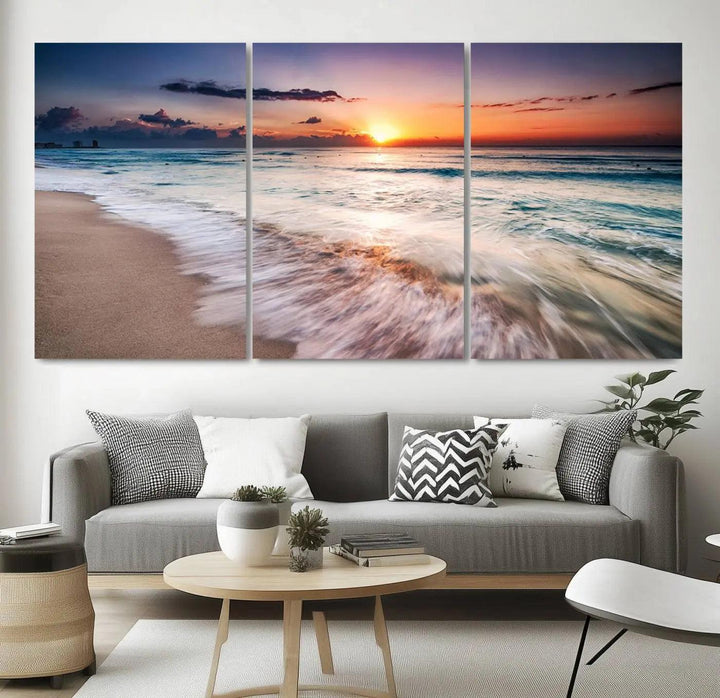 A serene triptych titled "Large Ocean Sunset Canvas Wall Art" features waves gently crashing under a golden reflection. This beach waves art print enhances the room's seaside ambiance.