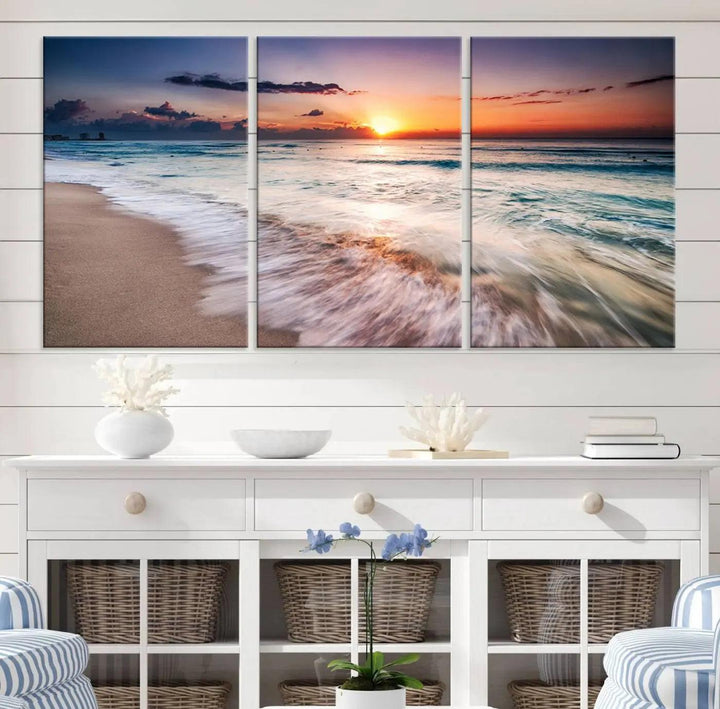 A serene triptych titled "Large Ocean Sunset Canvas Wall Art" features waves gently crashing under a golden reflection. This beach waves art print enhances the room's seaside ambiance.