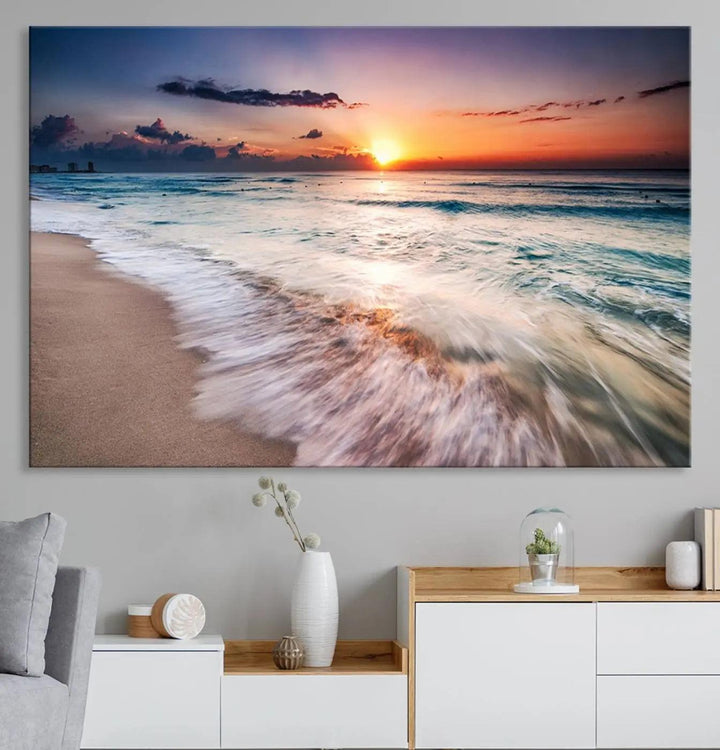 A serene triptych titled "Large Ocean Sunset Canvas Wall Art" features waves gently crashing under a golden reflection. This beach waves art print enhances the room's seaside ambiance.