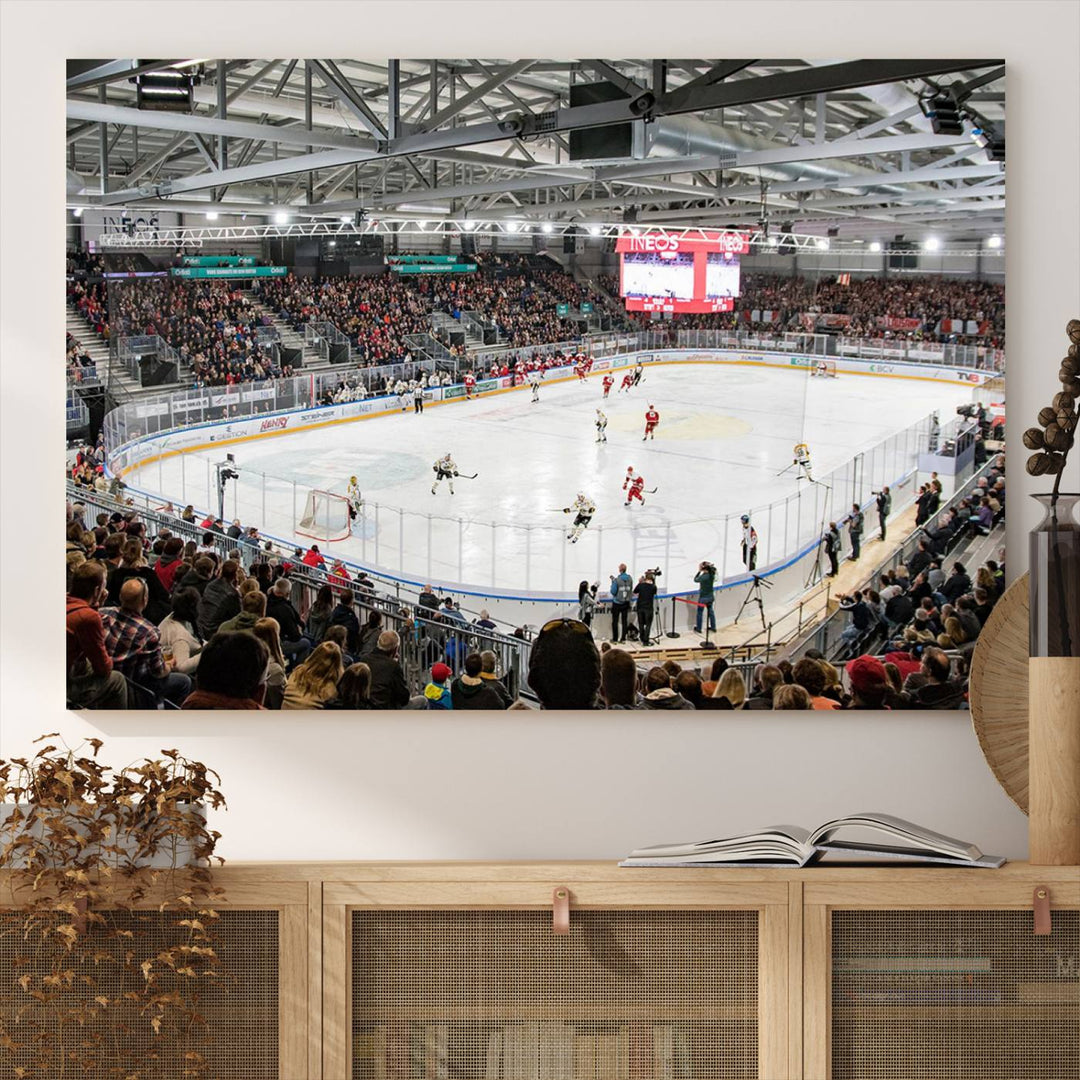 Fans peering through large windows can immerse themselves in a bustling ice hockey rink scene as vividly captured on the museum-quality Lausanne Arena Ice Hockey Stadium Wall Art Canvas Print. The intense energy and excitement of the game are brought to life in this stunning piece.