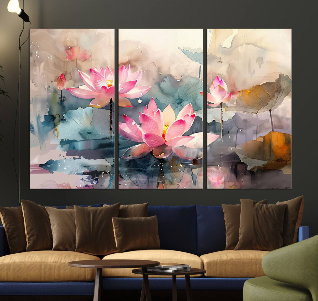 A dark wall is adorned with the Lotus Flower Wall Art, a 3-panel giclee canvas print that features pink lotus blossoms with green and brown leaves.