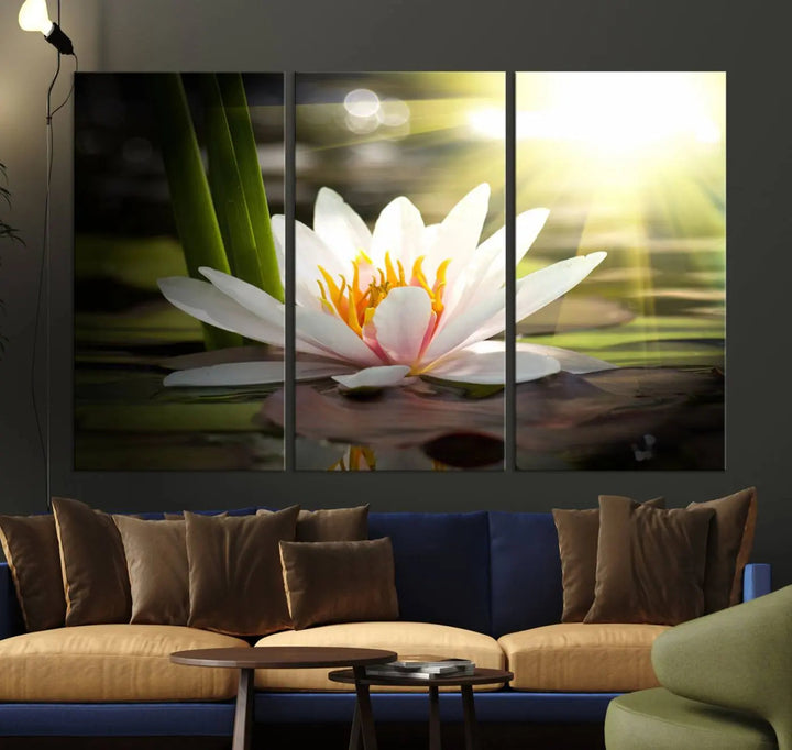 A serene Lotus Flower Wall Art Canvas Print depicts a water lily with sun rays, beautifully displayed on a light-colored wall.