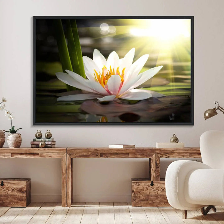 A serene Lotus Flower Wall Art Canvas Print depicts a water lily with sun rays, beautifully displayed on a light-colored wall.