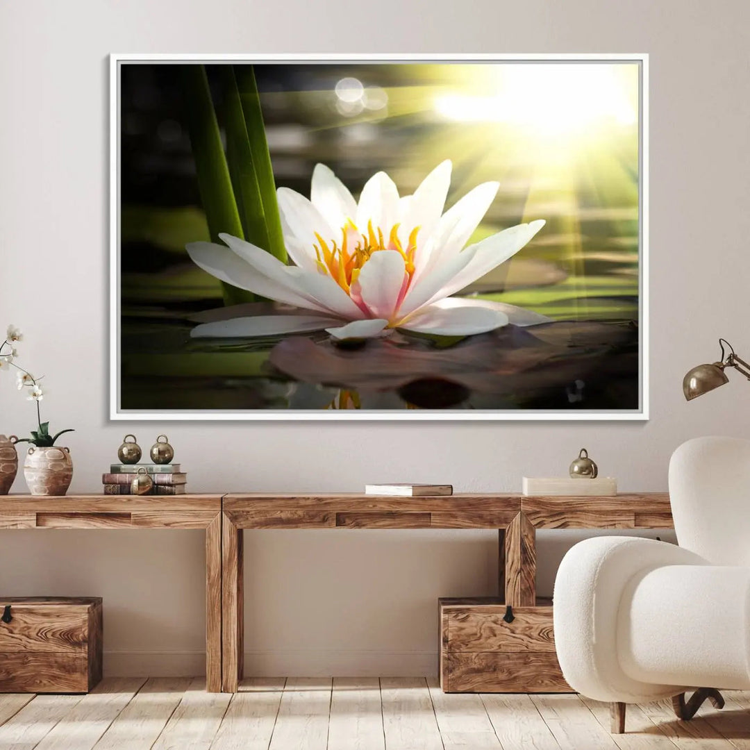 A serene Lotus Flower Wall Art Canvas Print depicts a water lily with sun rays, beautifully displayed on a light-colored wall.