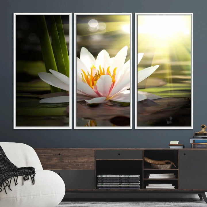 A serene Lotus Flower Wall Art Canvas Print depicts a water lily with sun rays, beautifully displayed on a light-colored wall.