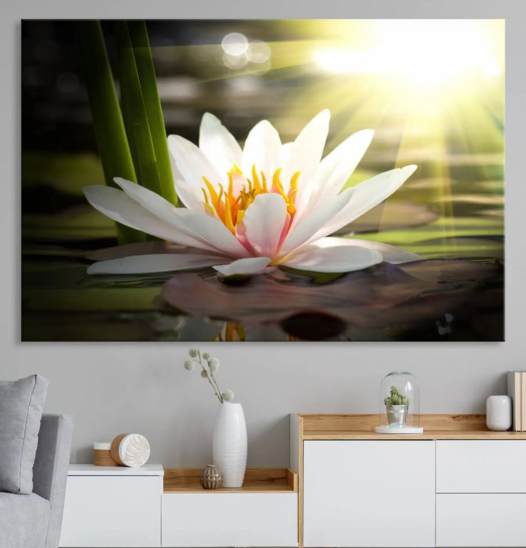 A serene Lotus Flower Wall Art Canvas Print depicts a water lily with sun rays, beautifully displayed on a light-colored wall.