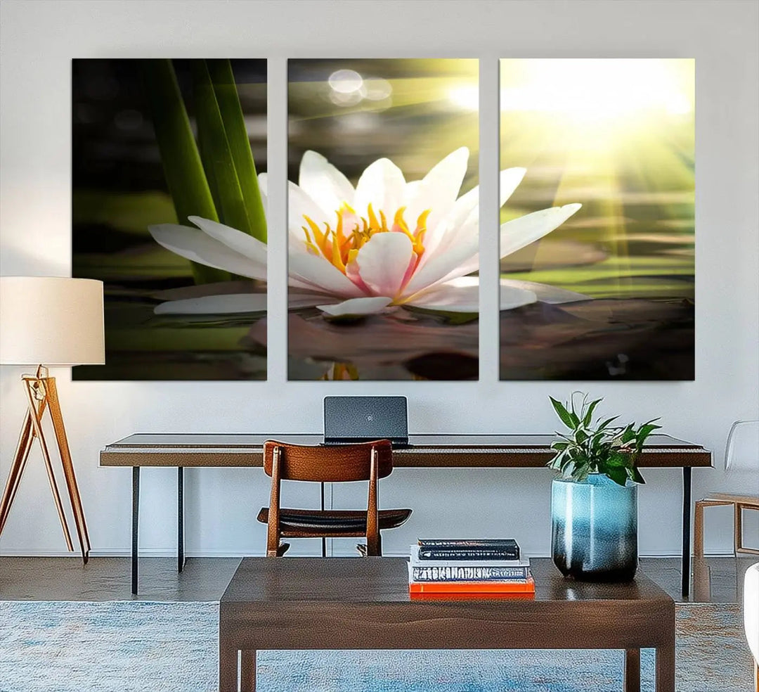 A serene Lotus Flower Wall Art Canvas Print depicts a water lily with sun rays, beautifully displayed on a light-colored wall.