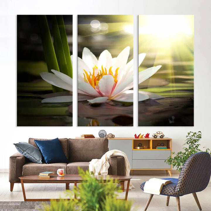 A serene Lotus Flower Wall Art Canvas Print depicts a water lily with sun rays, beautifully displayed on a light-colored wall.