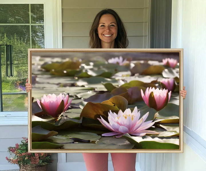 A dining room with a Lotus Flower Wall Art Canvas Print featuring pink water lilies.