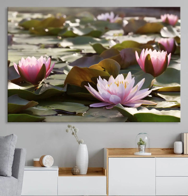 A dining room with a Lotus Flower Wall Art Canvas Print featuring pink water lilies.