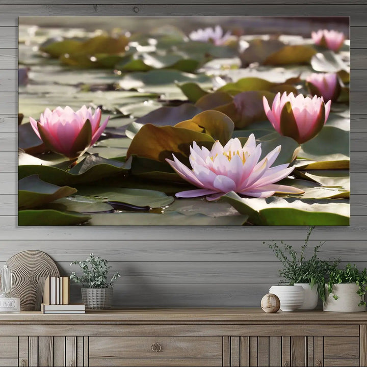 A dining room with a Lotus Flower Wall Art Canvas Print featuring pink water lilies.