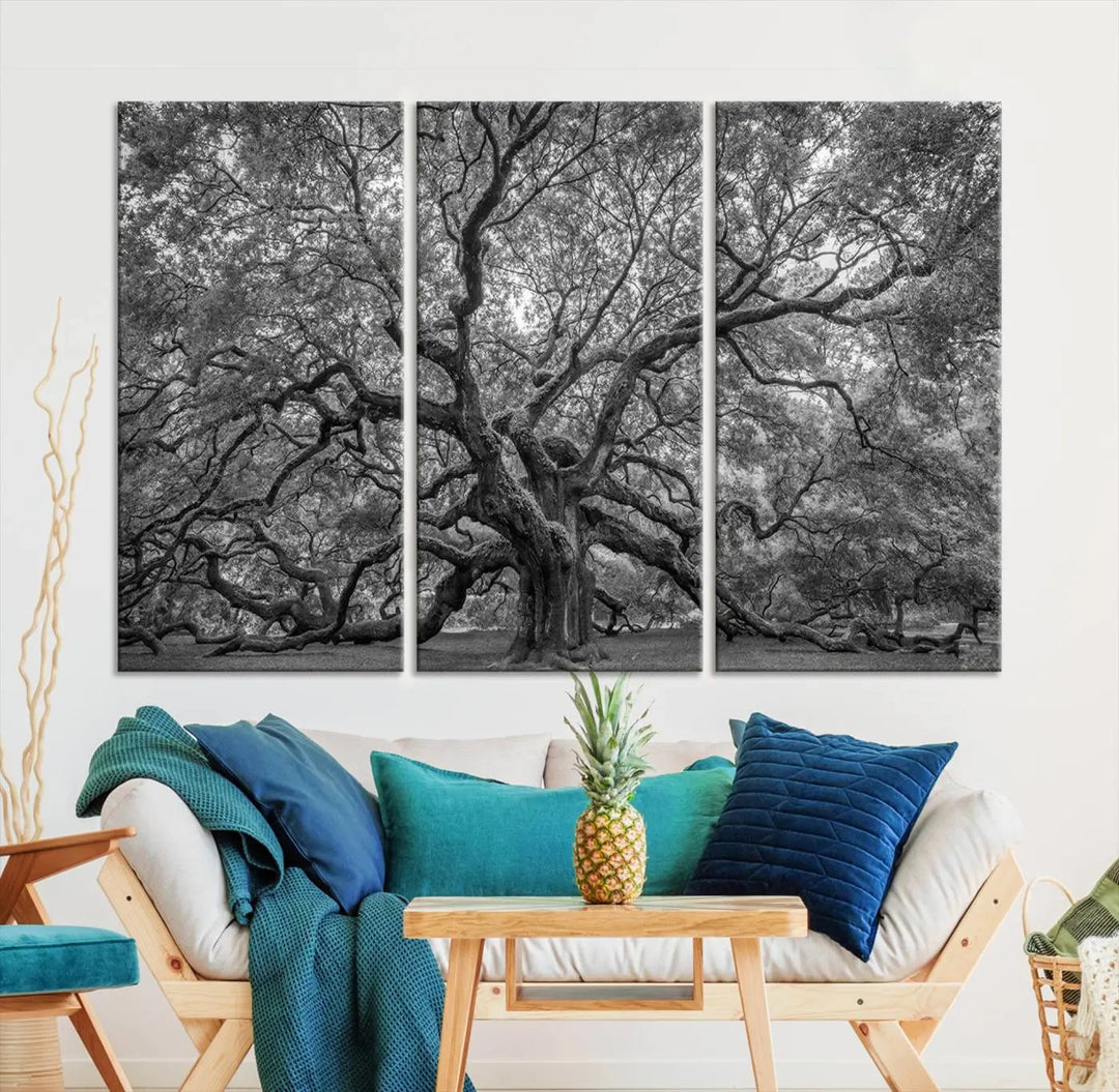 A modern living room highlighted by a striking Majestic Angel Oak Tree Black and White Canvas Print—Multi Panel Wall Art, Giclée Print—adorning the wall.