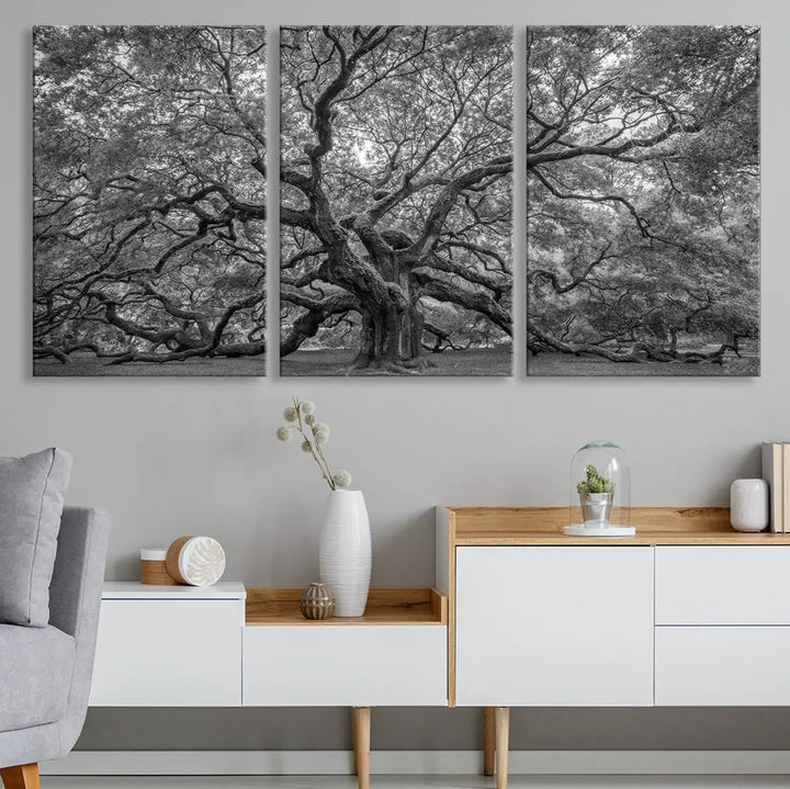 A modern living room highlighted by a striking Majestic Angel Oak Tree Black and White Canvas Print—Multi Panel Wall Art, Giclée Print—adorning the wall.