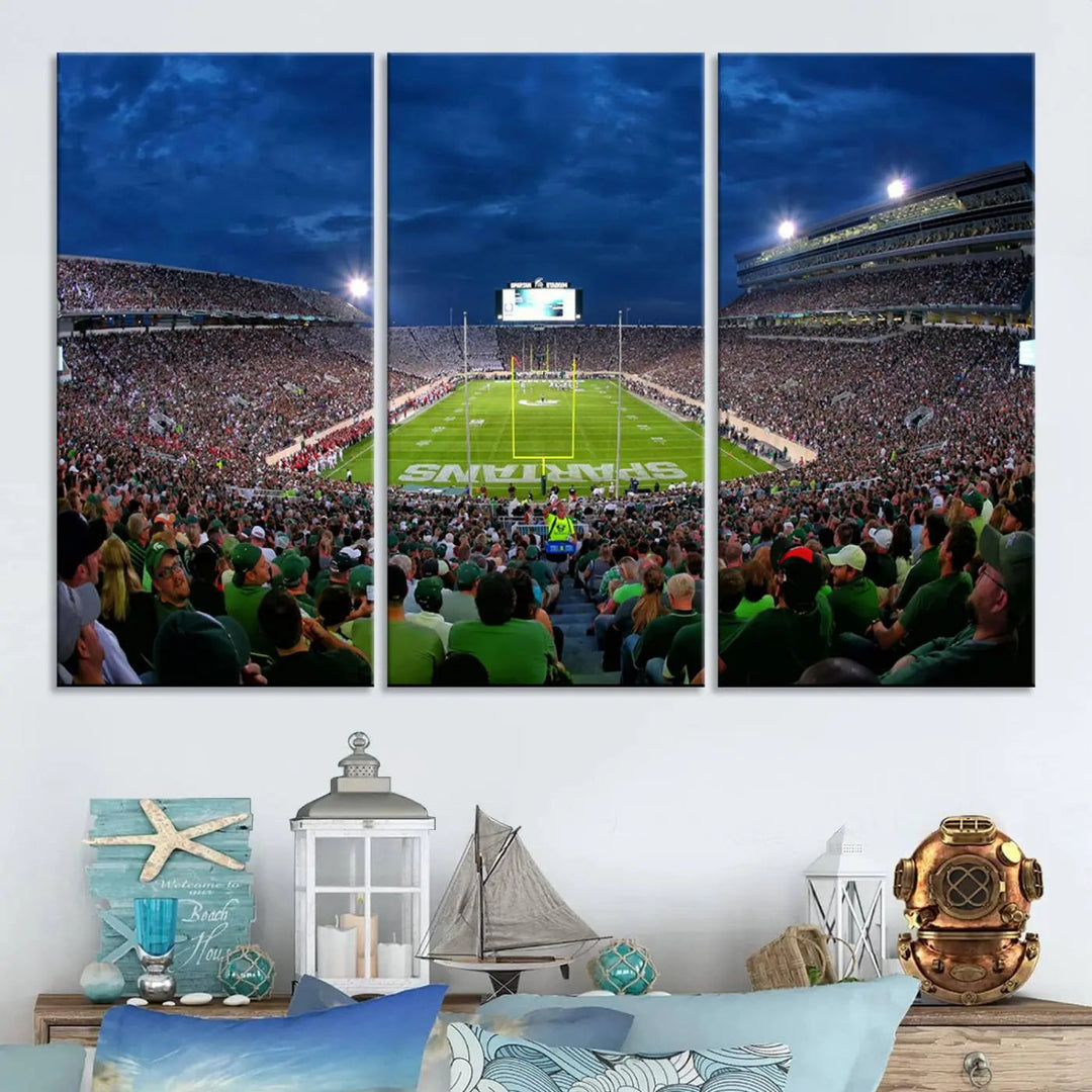 The living room features a Michigan State Spartans Football Team Print, showcasing East Lansing's Spartan Stadium as a triptych wall art above the sofa.