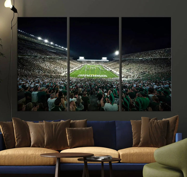 The Michigan State Spartans Football Team Print features an impressive depiction of East Lansing's Spartan Stadium at night, packed with enthusiastic fans. This captivating wall art boasts a gallery-quality finish that enchants any viewer.