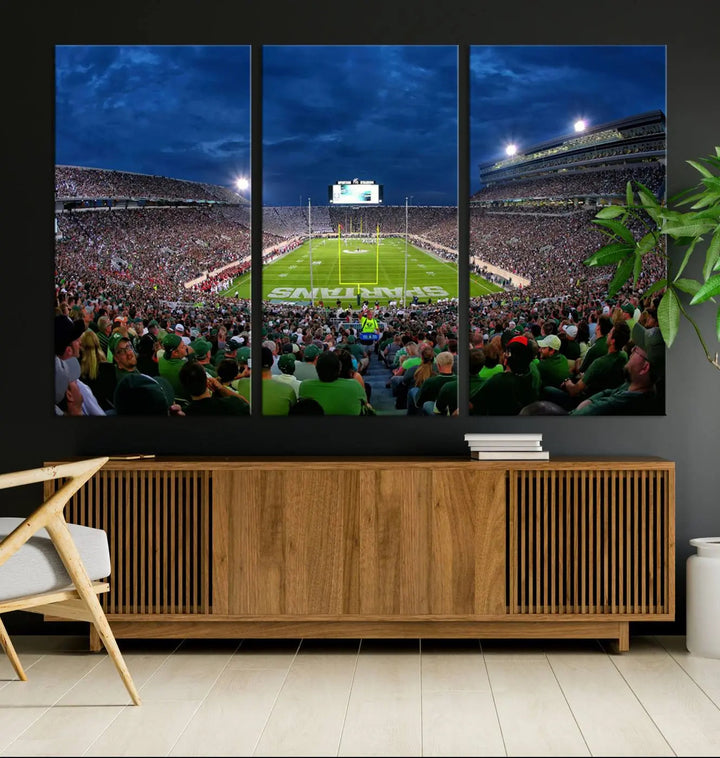 The living room features a Michigan State Spartans Football Team Print, showcasing East Lansing's Spartan Stadium as a triptych wall art above the sofa.