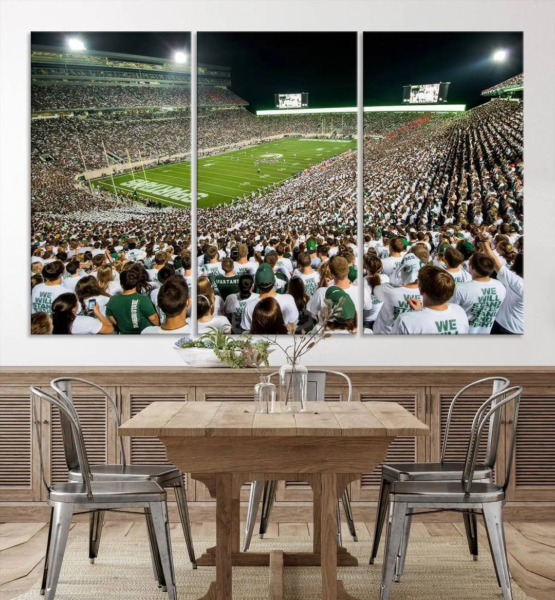 Above the dining table, a gallery-quality Michigan State Spartans Football Team Print on premium canvas is displayed, featuring a panoramic view of East Lansing's Spartan Stadium.