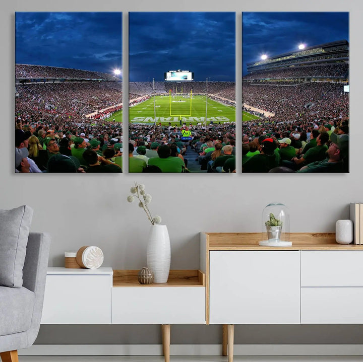 The living room features a Michigan State Spartans Football Team Print, showcasing East Lansing's Spartan Stadium as a triptych wall art above the sofa.