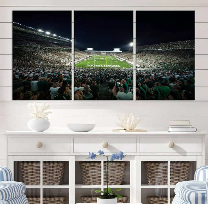 The Michigan State Spartans Football Team Print features an impressive depiction of East Lansing's Spartan Stadium at night, packed with enthusiastic fans. This captivating wall art boasts a gallery-quality finish that enchants any viewer.