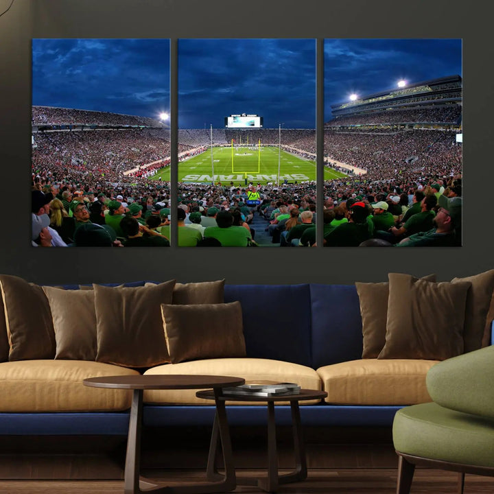 The living room features a Michigan State Spartans Football Team Print, showcasing East Lansing's Spartan Stadium as a triptych wall art above the sofa.