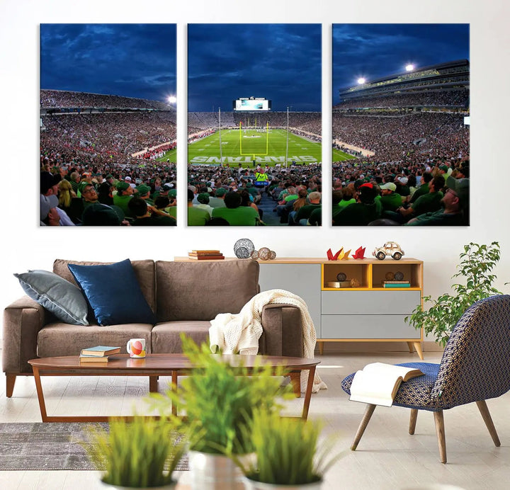 The living room features a Michigan State Spartans Football Team Print, showcasing East Lansing's Spartan Stadium as a triptych wall art above the sofa.