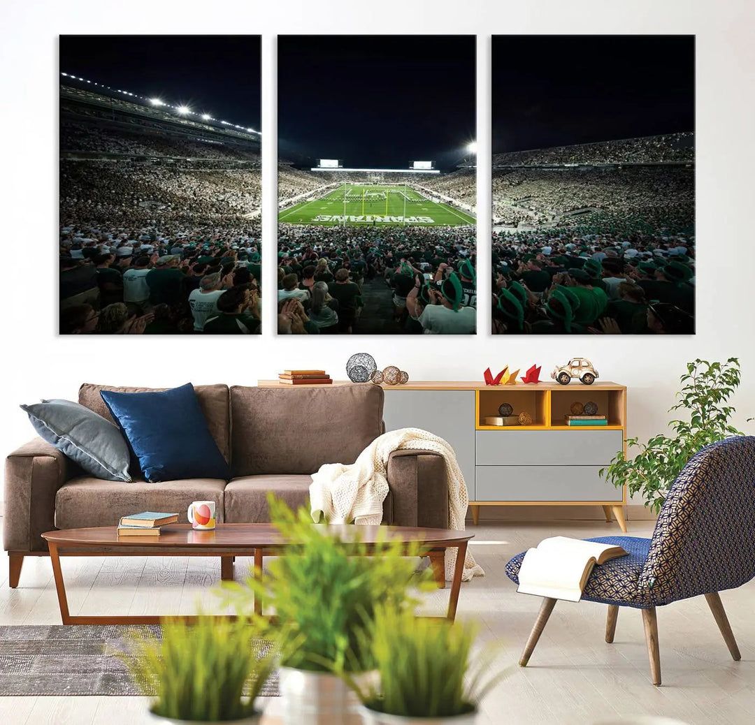 The Michigan State Spartans Football Team Print features an impressive depiction of East Lansing's Spartan Stadium at night, packed with enthusiastic fans. This captivating wall art boasts a gallery-quality finish that enchants any viewer.