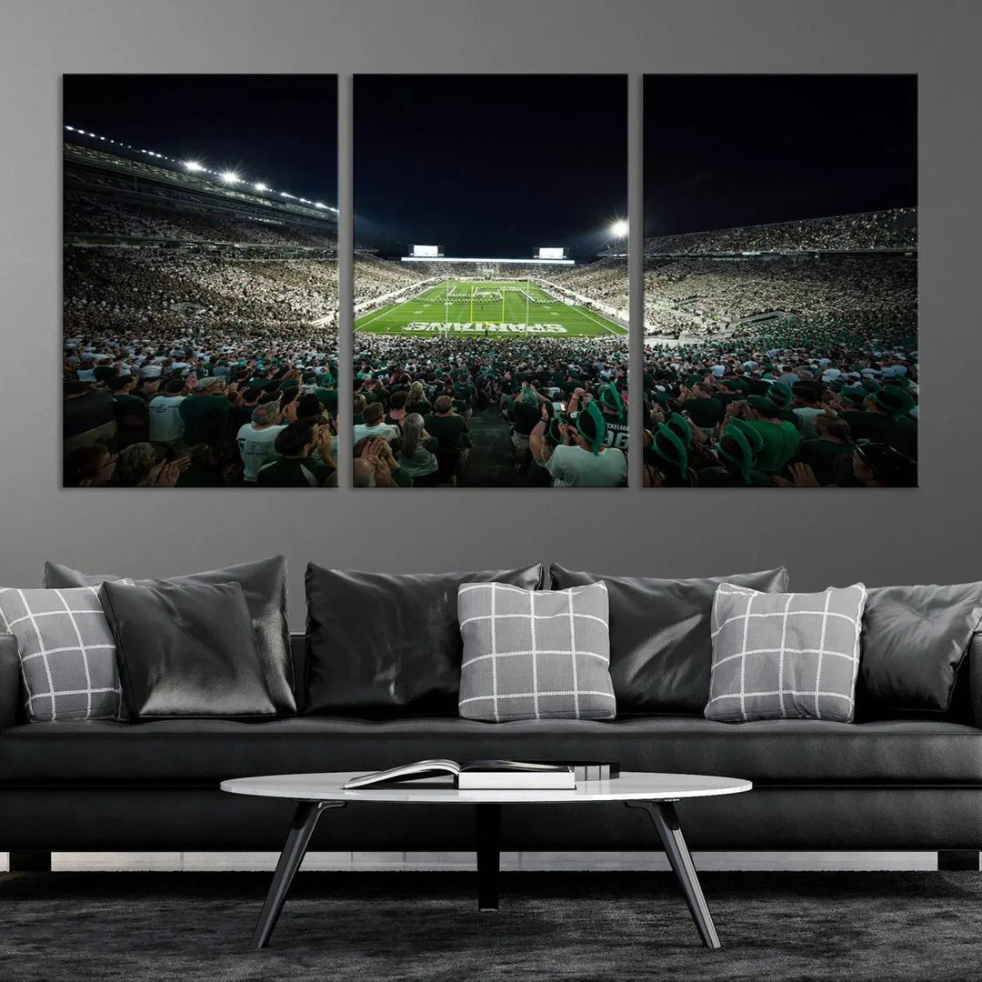 The Michigan State Spartans Football Team Print features an impressive depiction of East Lansing's Spartan Stadium at night, packed with enthusiastic fans. This captivating wall art boasts a gallery-quality finish that enchants any viewer.