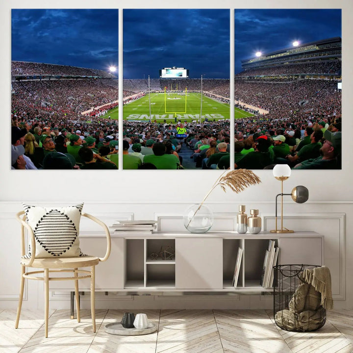 The living room features a Michigan State Spartans Football Team Print, showcasing East Lansing's Spartan Stadium as a triptych wall art above the sofa.