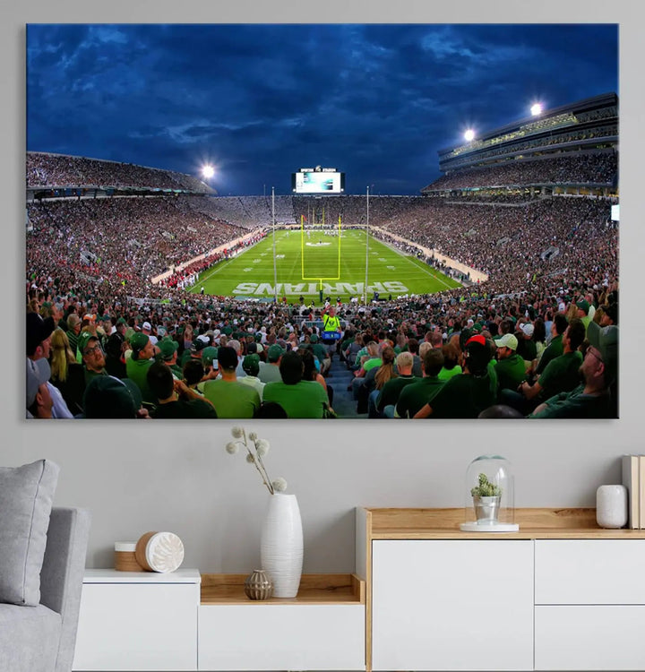 The living room features a Michigan State Spartans Football Team Print, showcasing East Lansing's Spartan Stadium as a triptych wall art above the sofa.