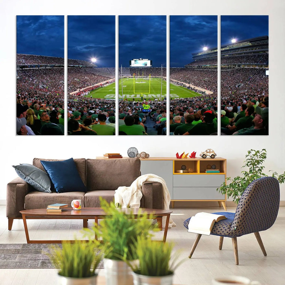 The living room features a Michigan State Spartans Football Team Print, showcasing East Lansing's Spartan Stadium as a triptych wall art above the sofa.