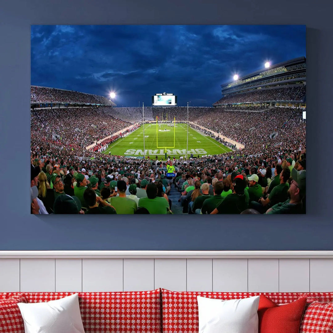 The living room features a Michigan State Spartans Football Team Print, showcasing East Lansing's Spartan Stadium as a triptych wall art above the sofa.