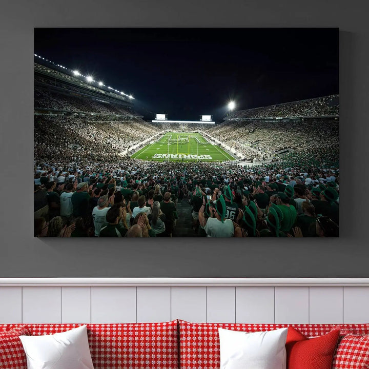 The Michigan State Spartans Football Team Print features an impressive depiction of East Lansing's Spartan Stadium at night, packed with enthusiastic fans. This captivating wall art boasts a gallery-quality finish that enchants any viewer.